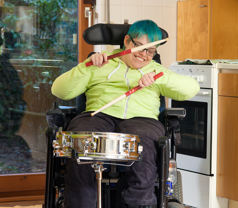 child with disability playing drum
