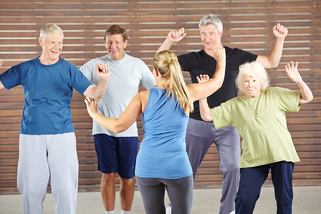 instructor with elderly dance class