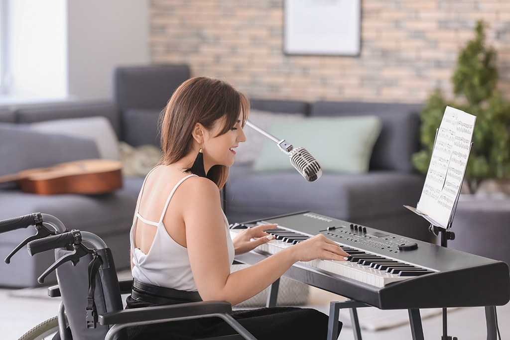 women in wheelchair playing piano